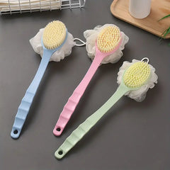 Three bath brushes with yellow bristles on a gray surface.
