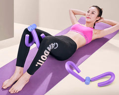 Woman exercising on a purple mat with a purple resistance tool