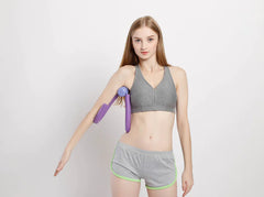 Woman holding a purple arm exercise device against a white background