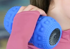 Person using a blue massage roller on their shoulder against a blurred background