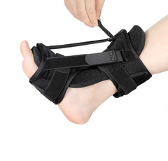 Black foot brace being worn on a white background
