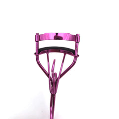 Pink eyelash curler on a white background