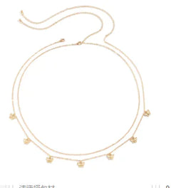 Gold necklace with small beads on a white background