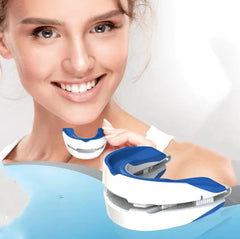 Woman holding a blue and white dental device with a plain background