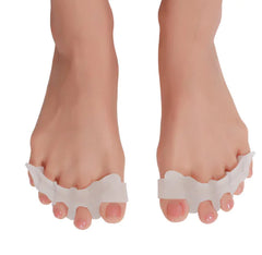 Silicone toe separators on a person's feet with a white background