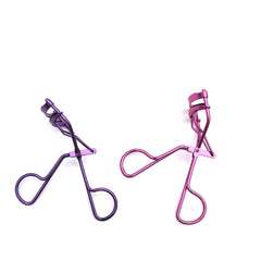 Two eyelash curlers on a white background