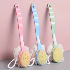 Three colorful scrub brushes with soft bristles on a pink background