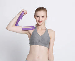 Woman exercising with a purple resistance tool on a white background