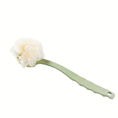 Green bath brush with a white loofah head on a white background