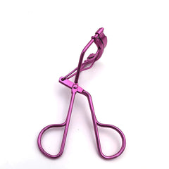 Pink eyelash curler on a white background