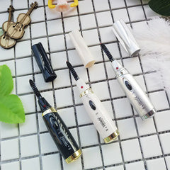 Set of eyelash extensions tools on a checkered surface with decorative items.