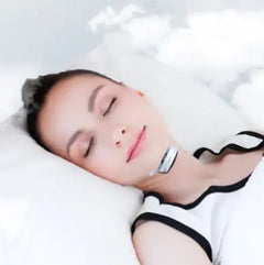 Person lying down with a device under chin on white pillow and light background