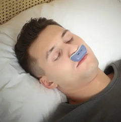 Man lying on a pillow with a blue device on his face