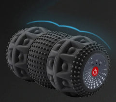 Black textured foam roller with a power button on a dark background