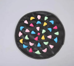 Round black mat with colorful triangle patterns on a gray background