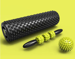 Black and yellow foam roller set on a green background
