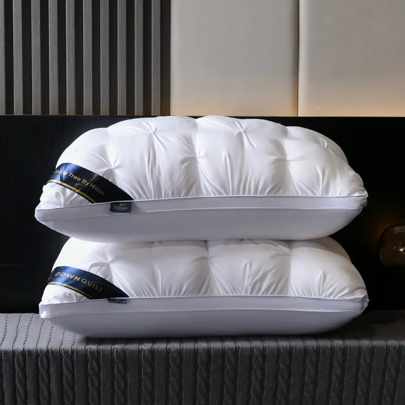 Two white pillows stacked on a textured surface with a blurred background