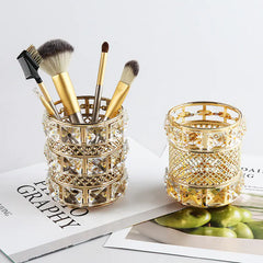 Decorative glass holders with makeup brushes on a magazine