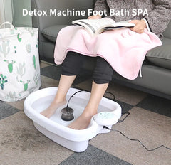 Person using a detox machine foot bath spa in a home setting.