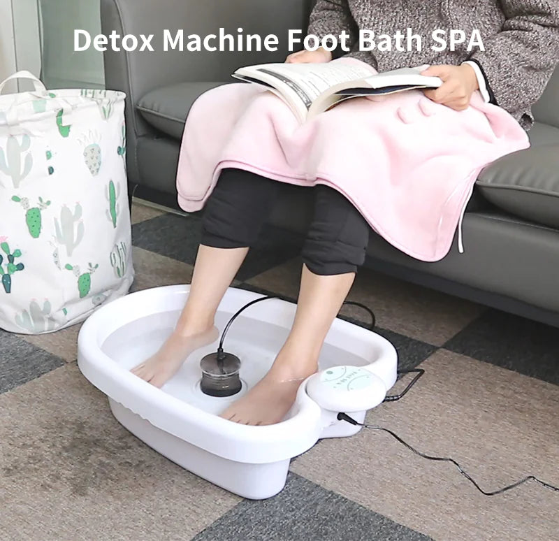 Person using a detox machine foot bath spa in a home setting.