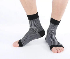 Black and gray striped socks worn by a person on a white background