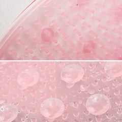 Close-up of pink gelatinous texture with bubbles, likely from a slime or gel product.