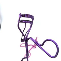 Purple eyelash curler on a white background