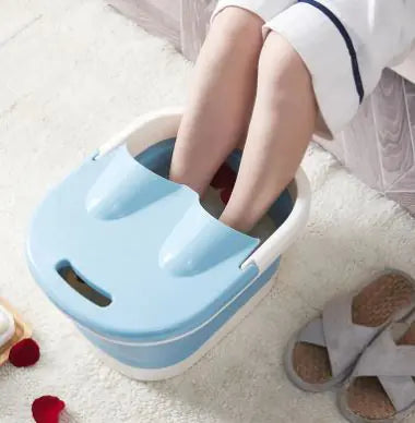 Person using a blue foot bath on a white carpet