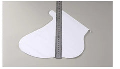 White foot sleeve piece with a ruler for scale on a gray background