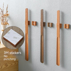Wooden wall hooks with 3M stickers on a gray wall