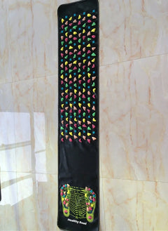 Colorful foot reflexology mat on a tiled floor