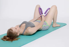 Woman using a resistance tool on a yoga mat with a white background