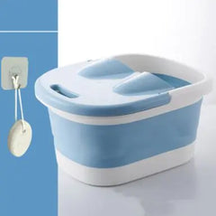 Blue and white plastic foot bath on a light blue background
